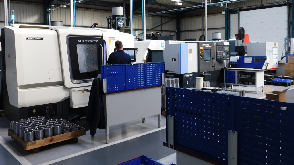 ADP team working on a NLX 2550 700 machine