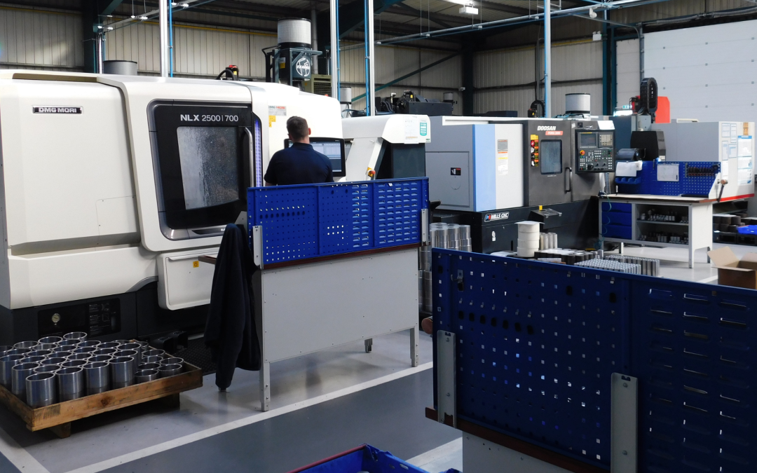 ADP team working on a NLX 2550 700 machine