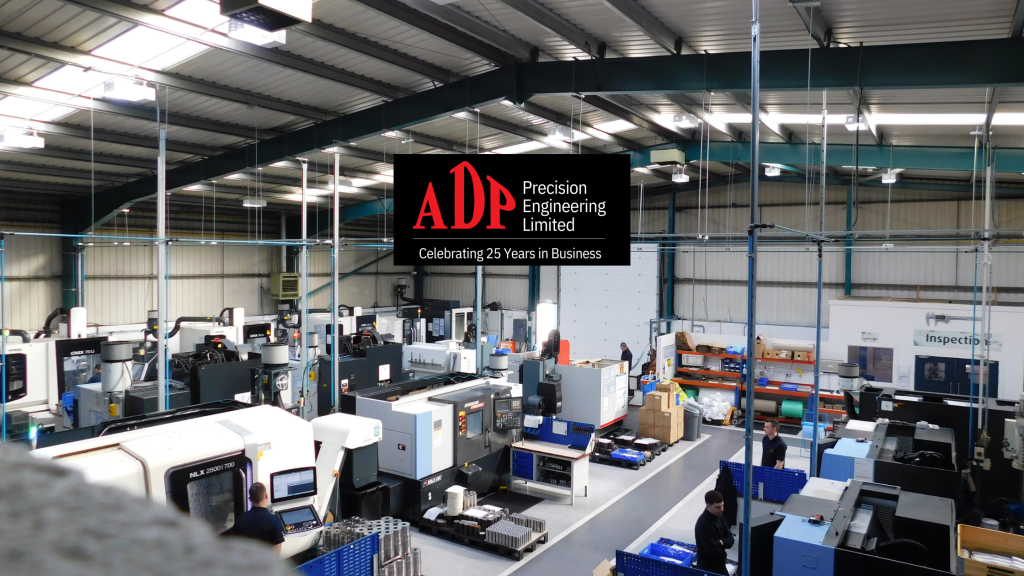 view of ADP from the balcony above machinery and our team working with ADP logo in the middle
