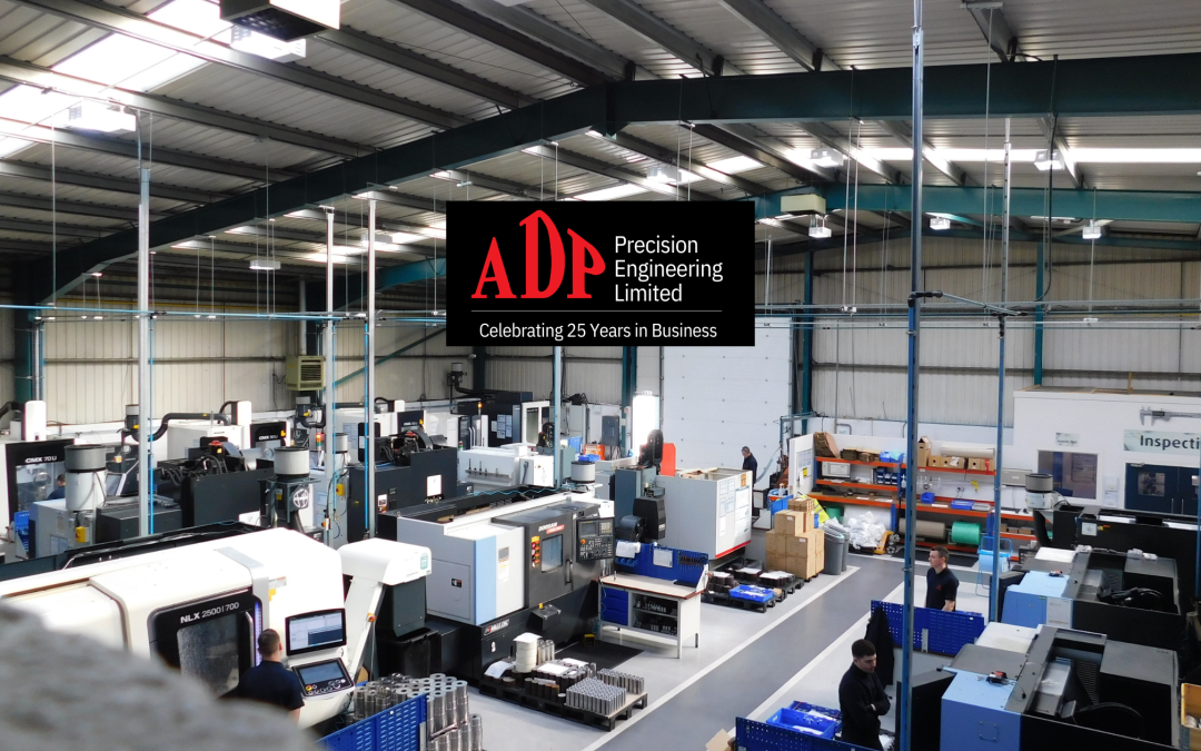 view of ADP from the balcony above machinery and our team working with ADP logo in the middle